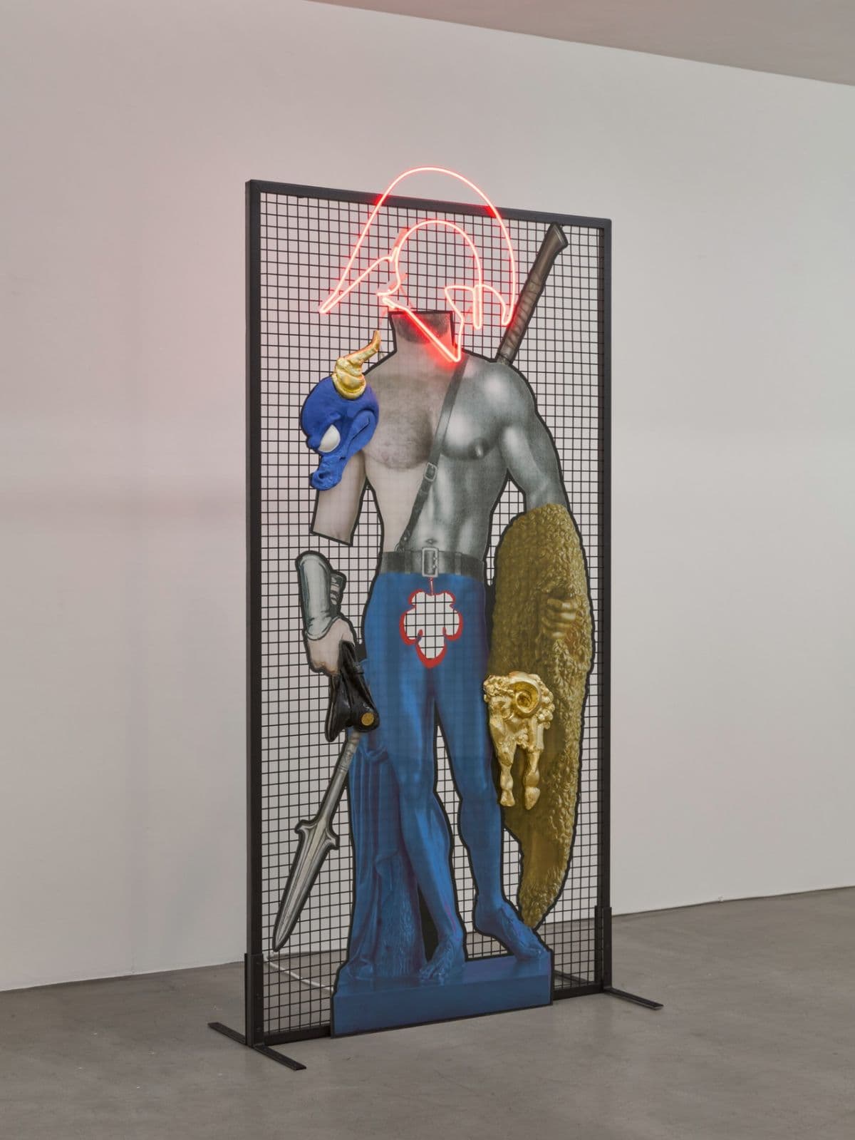 Spartan Spoils, mixed-media warrior sculpture by Grigorios Ilaridis with a neon Spartan helmet, dragon head, ram's head and layered sculptural elements. 